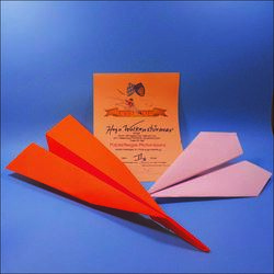 Papierflieger und Teilnahmeurkunde